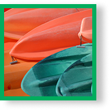 Close Up of Plastic Green and Orange Kayaks